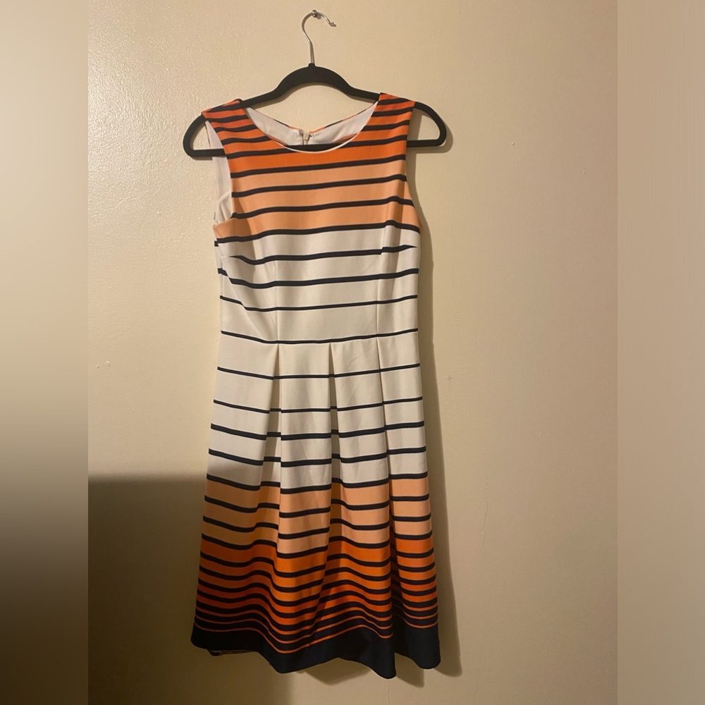 A dress in blue, pink, and white where blue stripes dominate the design.